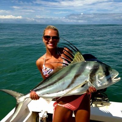 woman angler holding rooster fish